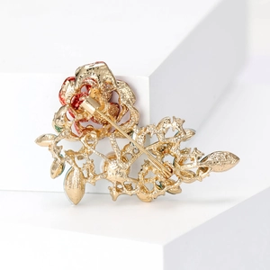 Elegant rose crystal brooch in gold with red petals and secure safety pin closure