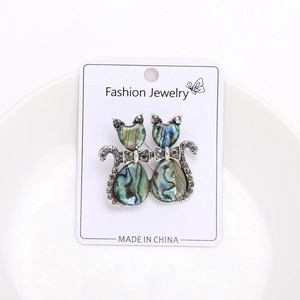 Detail of vintage cat brooch with iridescent abalone shell inlay and grey rhinestones