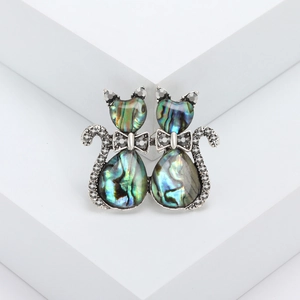 Retro cat brooch featuring colorful abalone shell and rhinestones on silver metal base