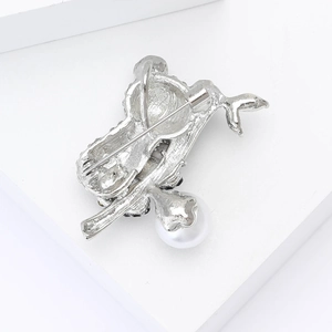 Macro view showing the sturdy safety pin clasp and white pearl on the panda brooch back