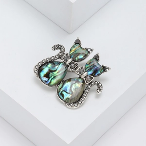 Vintage cat brooch with iridescent abalone shell and dark crystal accents in silver tone