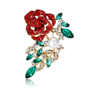 Elegant rose crystal brooch with red rhinestones and white pearl on golden branch