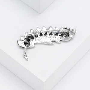 Detailed back view of feather-shaped abalone shell brooch with vintage silver finish pin