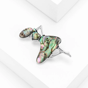 Elegant ballerina brooch with abalone shell inlay on white geometric display stand