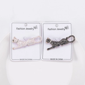 Detail of black and white enamel leopard brooches with sparkling rhinestone collars