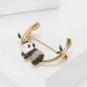 Cute panda brooch with rhinestones and green crystal leaves on a gold branch