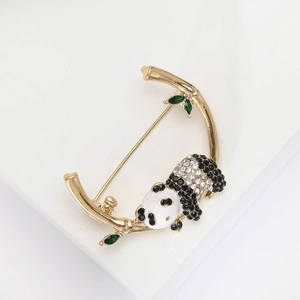 Cute panda brooch with black and white rhinestones holding a green bamboo branch