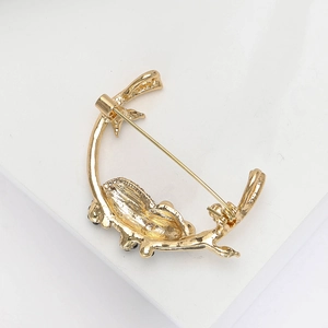 Detailed back view of a golden alloy panda brooch showing the safety pin clasp and texture