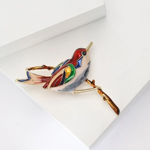 Exquisite enamel bird brooch pin on branch with vibrant colors for women coat
