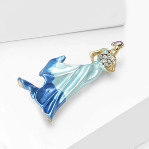 Detailed macro view of an elegant lady brooch with blue enamel dress and crystal accents