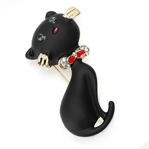 Broche chat noir en émail avec yeux en strass verts et n'ud papillon rouge cristal