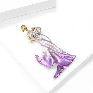 Detailed macro view of a golden dancer brooch with purple enamel gradient skirt and rhinestones