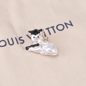 Detailed macro view of a graduation cat brooch with pearl finish and rhinestone graduation cap