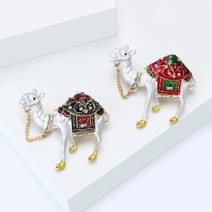 Exotic camel brooches with colorful enamel and sparkling rhinestones on white stands