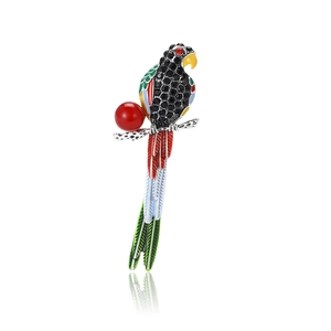 Broche perroquet détaillée avec strass noirs et émail coloré sur fond blanc épuré