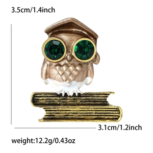 Detailed view showing owl brooch dimensions 3.5cm by 3.1cm with green rhinestone eyes