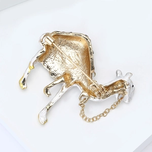 Detailed back view of camel brooch showing safety pin and security chain
