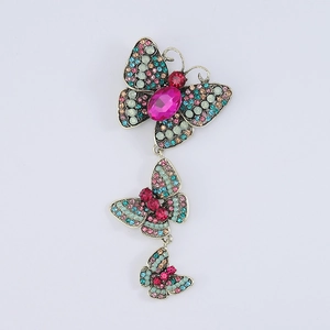 Detailed close-up of three-layered butterfly vintage brooch with colorful rhinestones