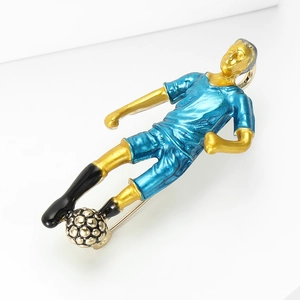 Macro shot of an alloy soccer player brooch with blue enamel jersey and silver ball detail
