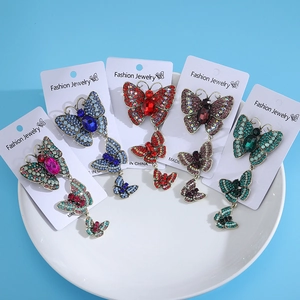 Five assorted butterfly brooches with crystal rhinestones on display cards