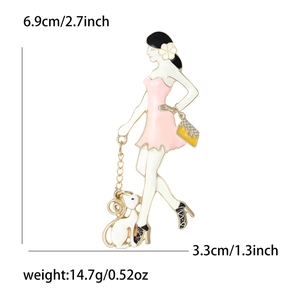 Enamel brooch detail showing lady with cat design measuring 6.9cm by 3.3cm