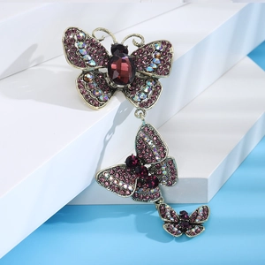 Detailed macro view of vintage butterfly brooch with purple crystals and gold alloy