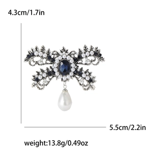 Detailed view of vintage bow brooch with blue gemstone, pearls and exact measurements