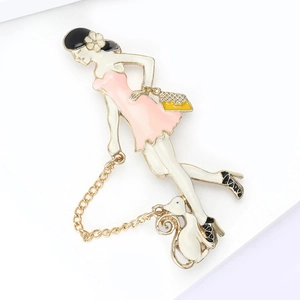 Detail of cartoon enamel brooch featuring an elegant lady in pink dress with white cat