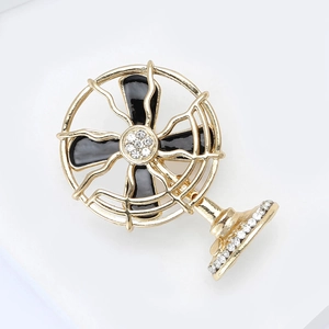 Detail of creative vintage fan brooch with gold frame, black enamel and sparkling crystals