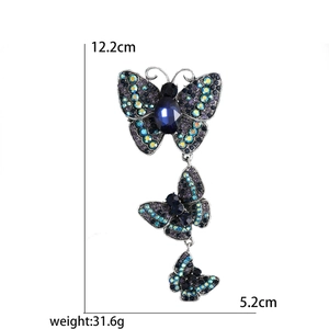 Vintage silver butterfly brooch with blue and purple crystals measuring 12.2 cm long