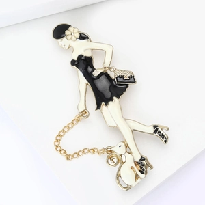 Detail of elegant enamel brooch featuring a lady in black dress and a small pet on a chain