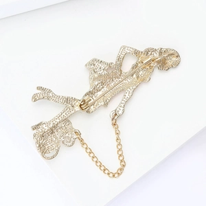 Detail view of the elegant brooch back with safety pin clasp and metal anti-lost chain