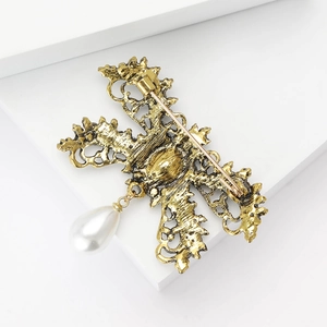 Detailed back view of vintage alloy butterfly brooch with safety pin and pearl drop