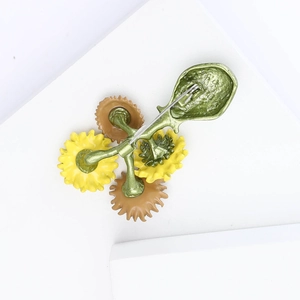 Detail showing back of sunflower vase brooch with silver safety pin and metal finish