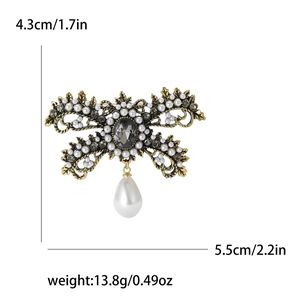 Vintage gold bow brooch with grey rhinestones and hanging teardrop pearl for suits