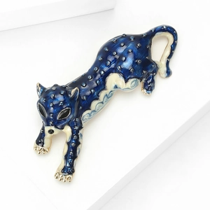 Detail of leopard brooch featuring blue and beige enamel with polished gold plating