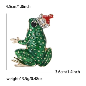 Broche grenouille en émail avec bonnet de Noël rouge et strass blancs étincelants