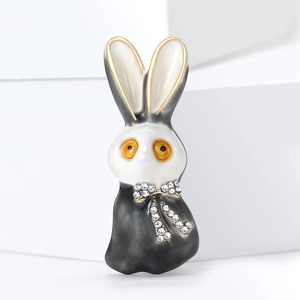 Modische schwarz-weiße Kaninchen-Brosche mit glitzernder Schleife und Goldrand-Details
