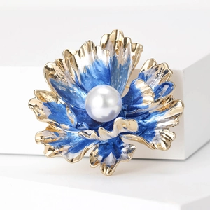 Exquisite peony flower brooch with blue enamel petals and center pearl on white stand