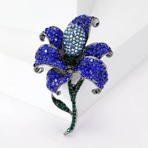 Blue rose brooch with colorful rhinestones on a minimalist white geometric background