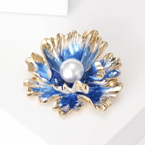 Detailed close-up of a blue enamel peony brooch with a large central pearl inlay
