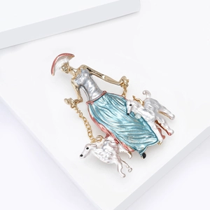 Artistic enamel brooch featuring a lady walking two dogs with blue gradient dress
