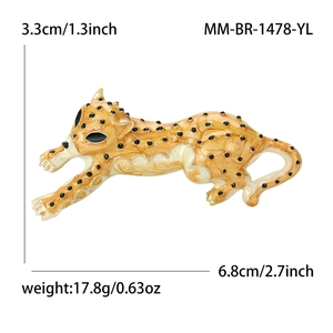 Golden cheetah brooch with black enamel spots and dimensions shown on white background