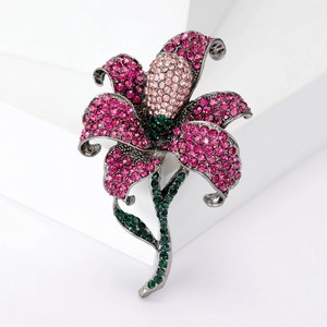 Sparkling lily brooch with pink rhinestones and gunmetal frame on white background
