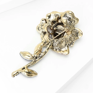 Detail view of the rose brooch back showing secure metal pin lock and hammer texture