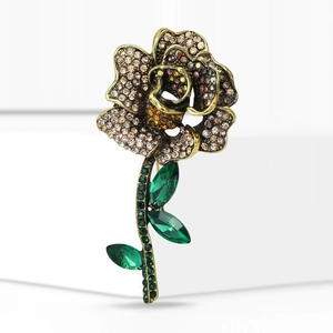 Detail of rose brooch featuring multi-color rhinestones and vintage gold plating