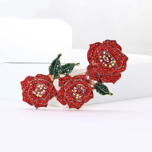 Élégante broche fleur en strass rouges avec feuilles vertes et métal doré brillant