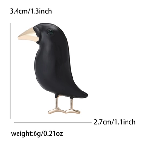 Gothic style black enamel crow brooch with gold accents and green gem eye for suits