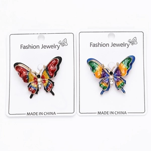 Detail of colorful enamel butterfly brooches with rhinestones on fashion jewelry cards