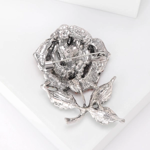 Silver rose brooch pin for women with red rhinestones and vintage metal texture detail